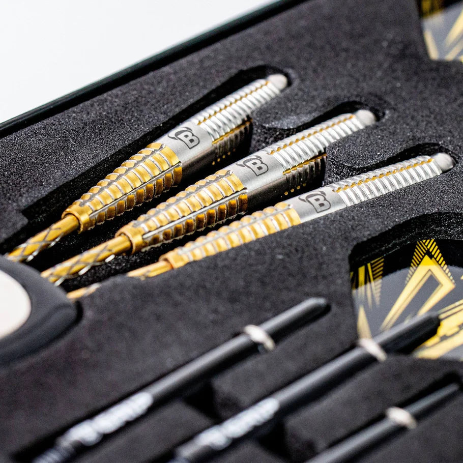 Angled close-up of 90% tungsten darts with precision grip barrels in foam packaging, gold and silver dart set details visible