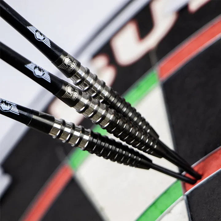 Angled close-up of three 90% tungsten darts grouped on dartboard, highlighting precision barrels and grip design in play