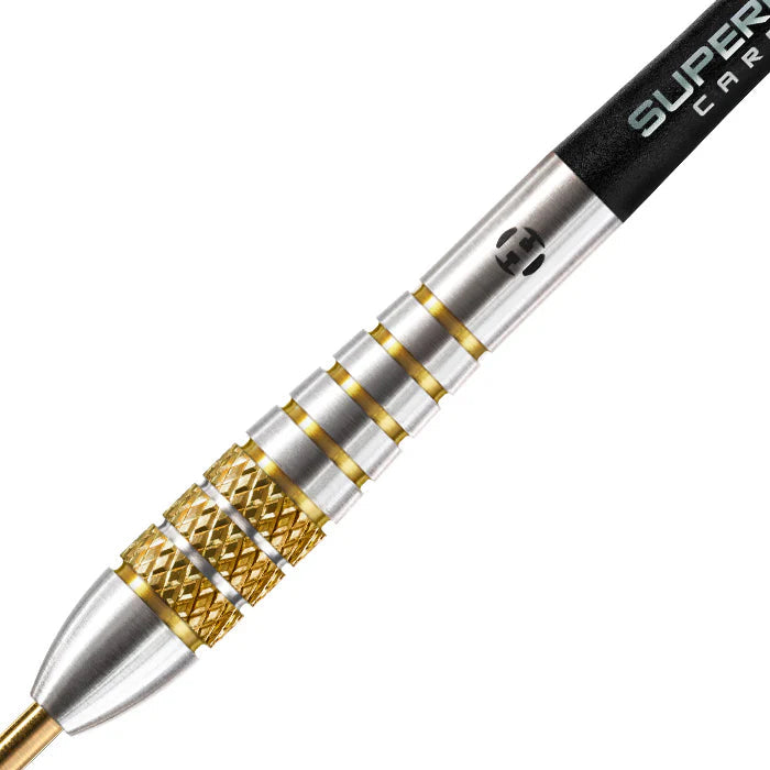 Close-up of tungsten dart barrel with gold knurled grip, ringed sections, and precision machined detailing on white background