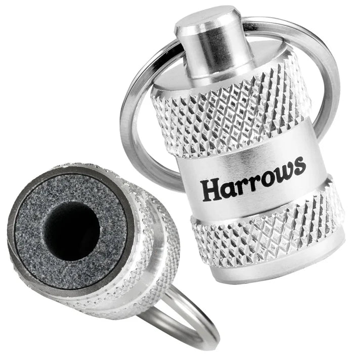 Close-up of dart sharpener key rings with knurled grip and visible sharpening stone, ideal dart accessory for maintaining point tips.
