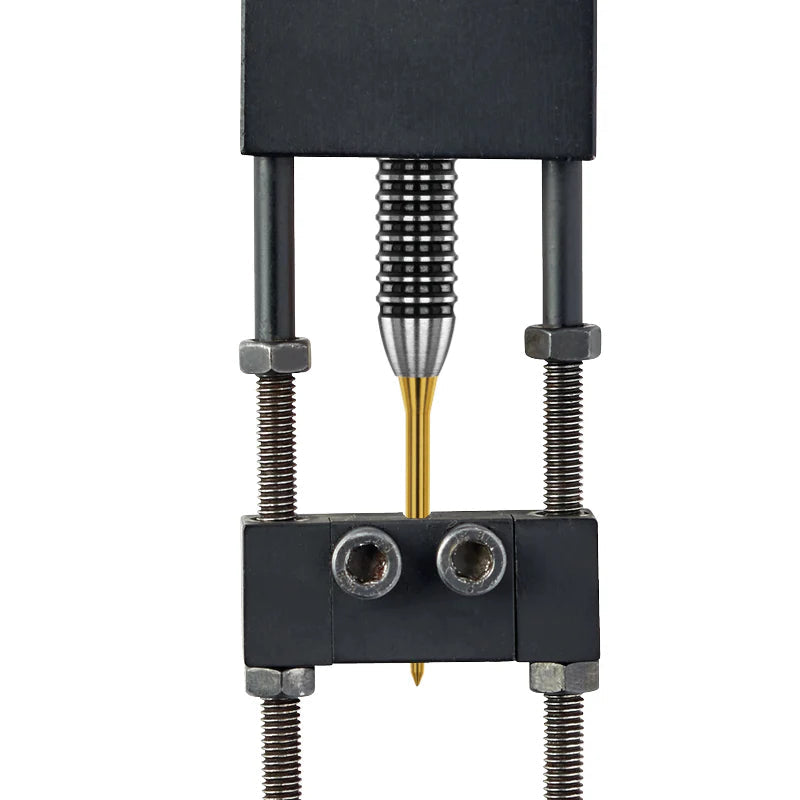 Gold Raptor dart point close-up in measuring tool, showing oversize tip and fine point detail for steel tip dart setup