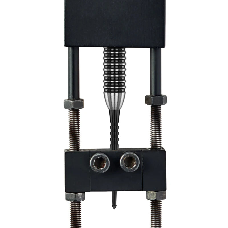 Close-up of Raptor GT dart point secured in test jig, showing ergonomic grip zone and spearhead tip design for dartboard retention