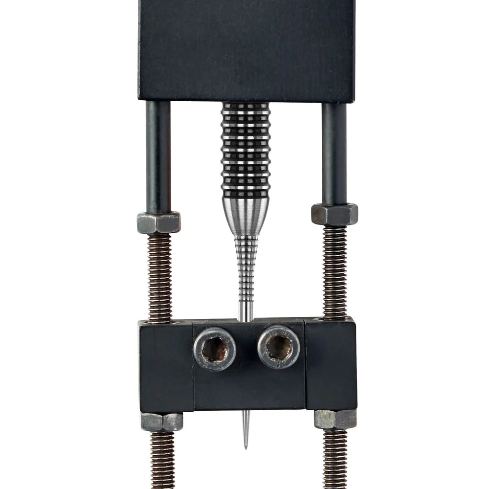 Top-down close-up of silver dart point in measuring clamp, showcasing knurled grip texture and sharp tip for precision darts