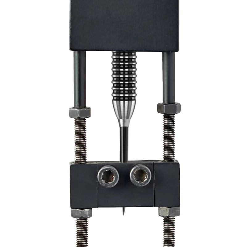 macro close-up of Trident Black Dart Point secured in a calibration tool, highlighting precision conical tip and grip rings
