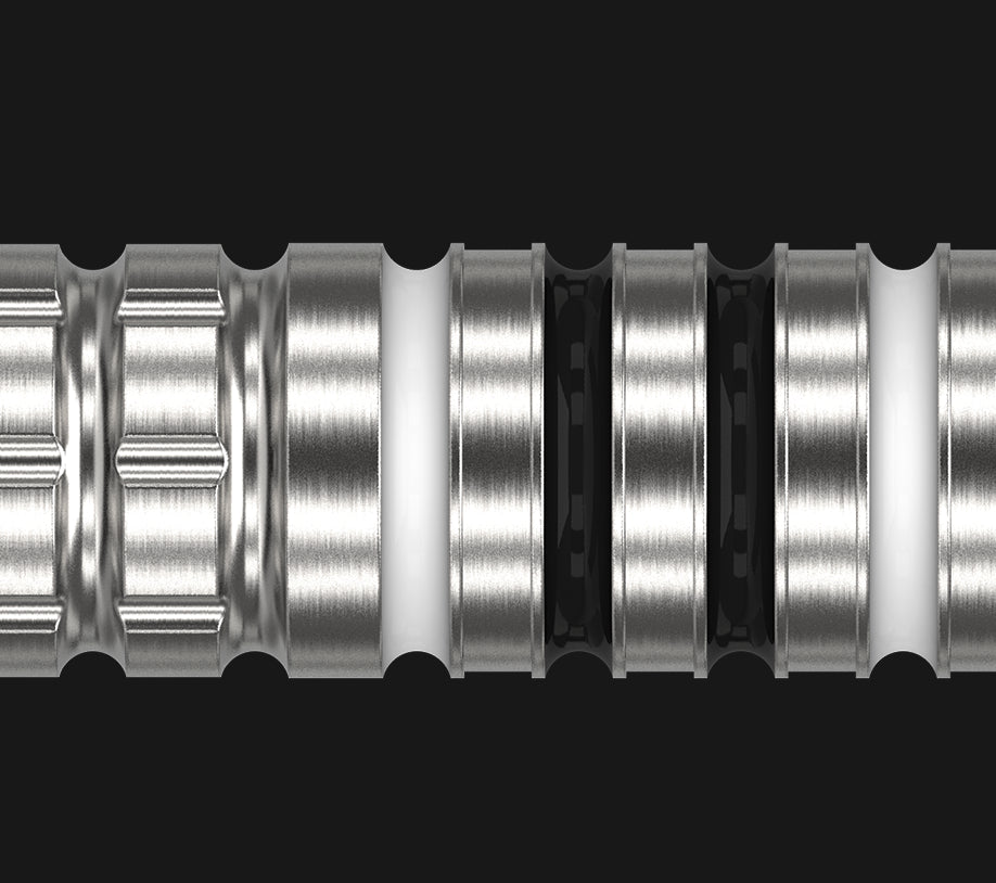 Macro close-up of 90% tungsten dart barrel highlighting precision grooves and grip rings, isolated on black background