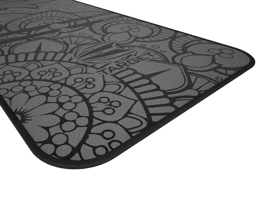 angled close-up of dart mat corner with detailed ink tattoo design, textured anti-slip surface, isolated on white background