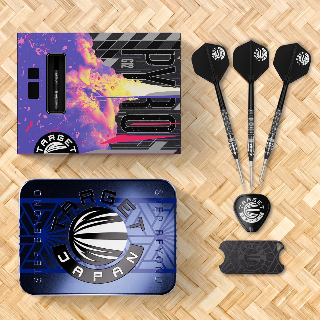 Target Japan Pyro G12 darts with black K-Flex flights, storage tin and packaging on a woven mat