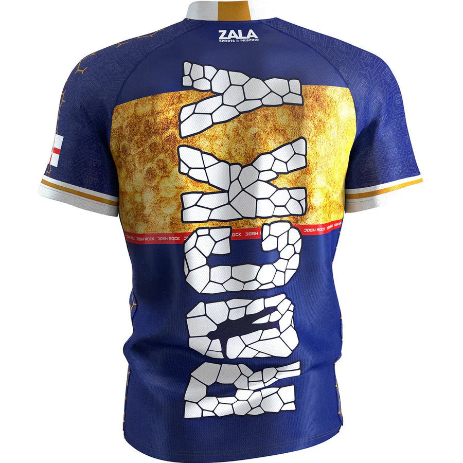 Back view of Josh Rock darts shirt with bold cracked stone design, gold accent, and detailed event graphics, isolated for darts apparel shoppers