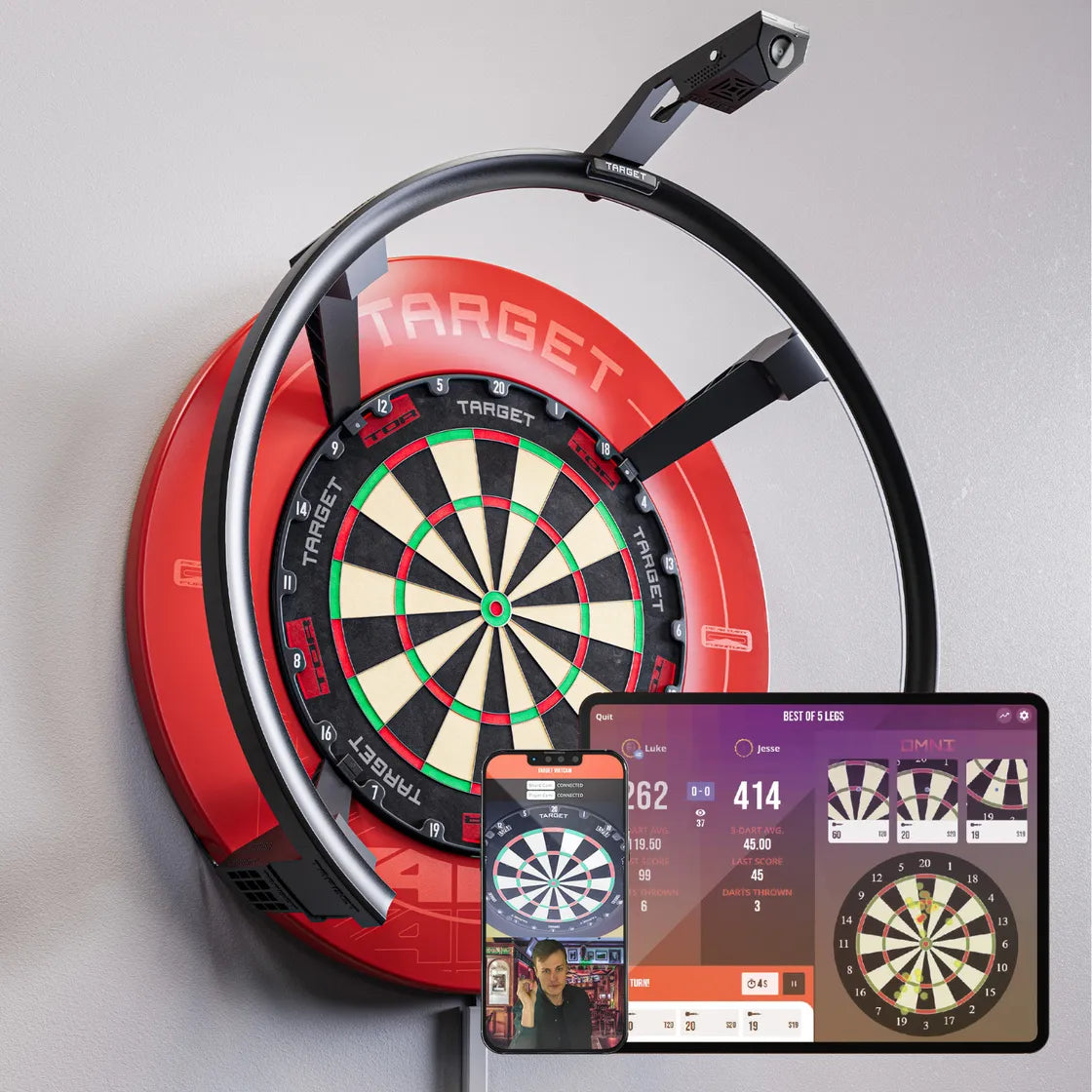 Angled view showing dartboard with Omni Virt Arm setup, score-tracking camera, and live dart scoring app interfaces on tablet and phone.