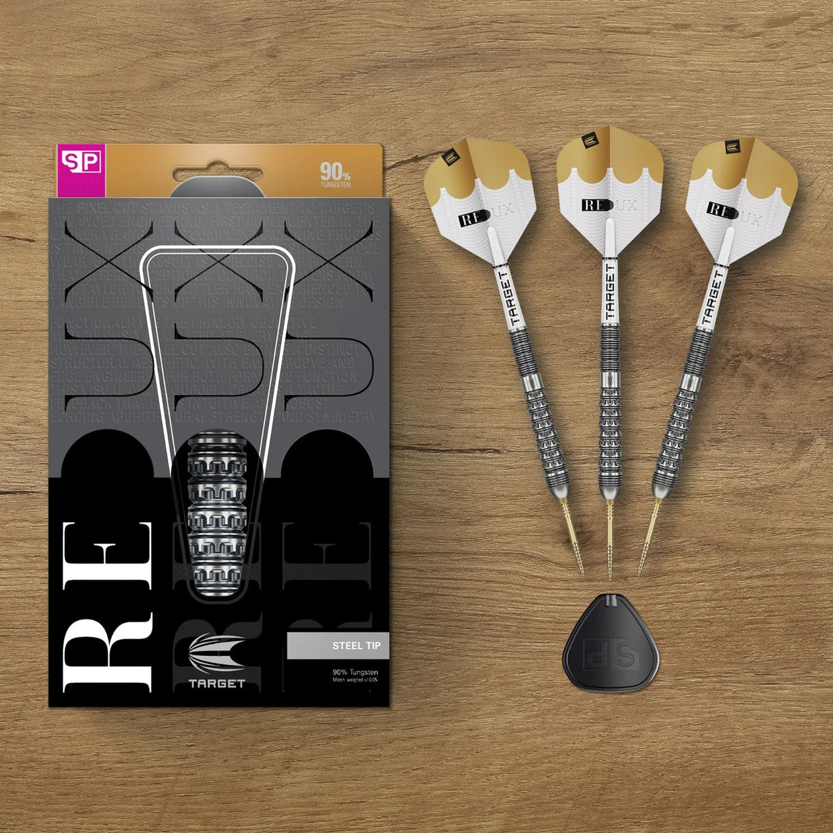 Top-down view of 90% tungsten steel tip darts with precision grip barrel and gold-white flights beside retail packaging on wood surface