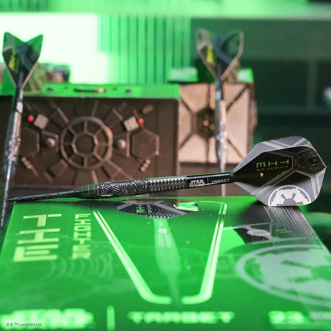 Angled view of three TIE Fighter 90% tungsten darts with detailed barrel grip and Star Wars flights, arranged with themed display box.