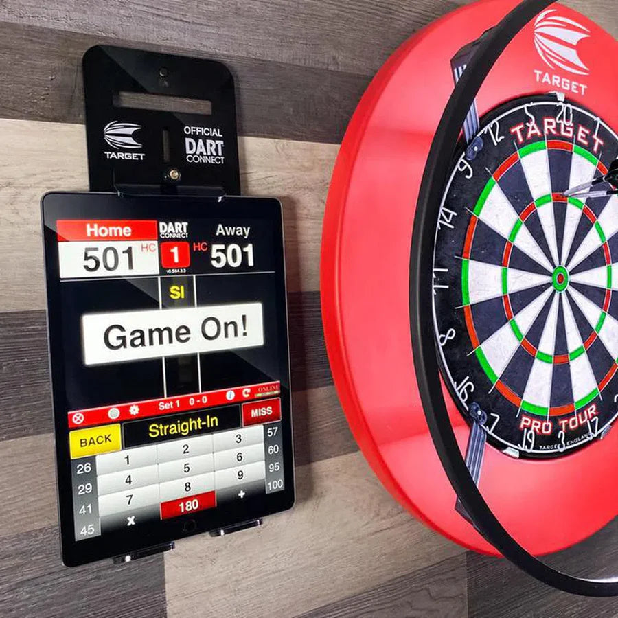Tablet holder securely mounted next to dartboard, displaying digital scoring for darts game, ideal for dart setup organization