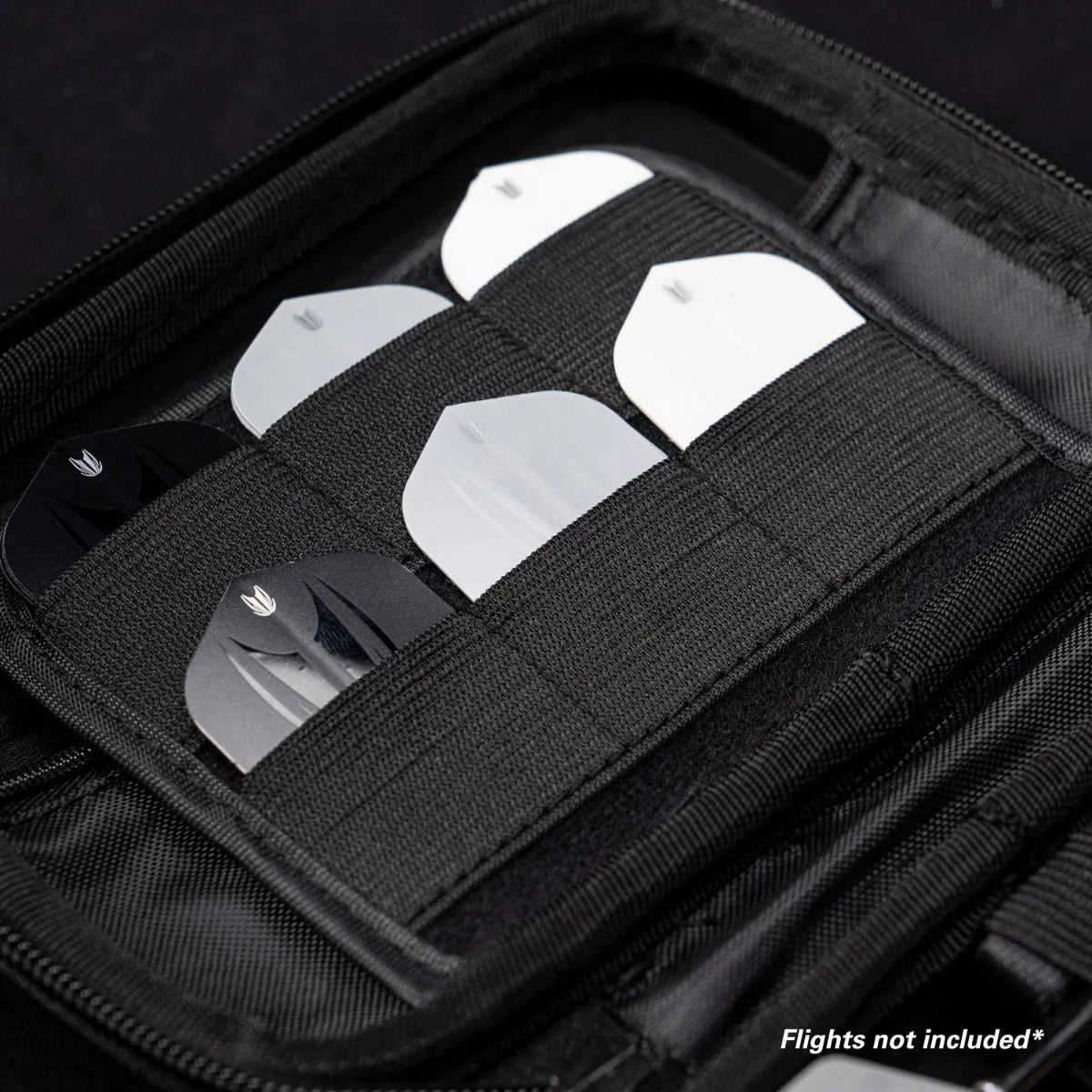 Angled close-up of dart case interior with elastic pockets holding black and white dart flights for organized storage