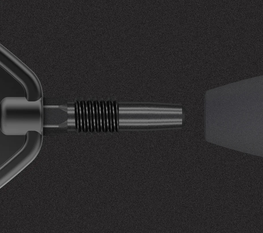 Close-up of 80% tungsten dart barrel and stem, black finish, showing detailed grip rings, isolated on dark background