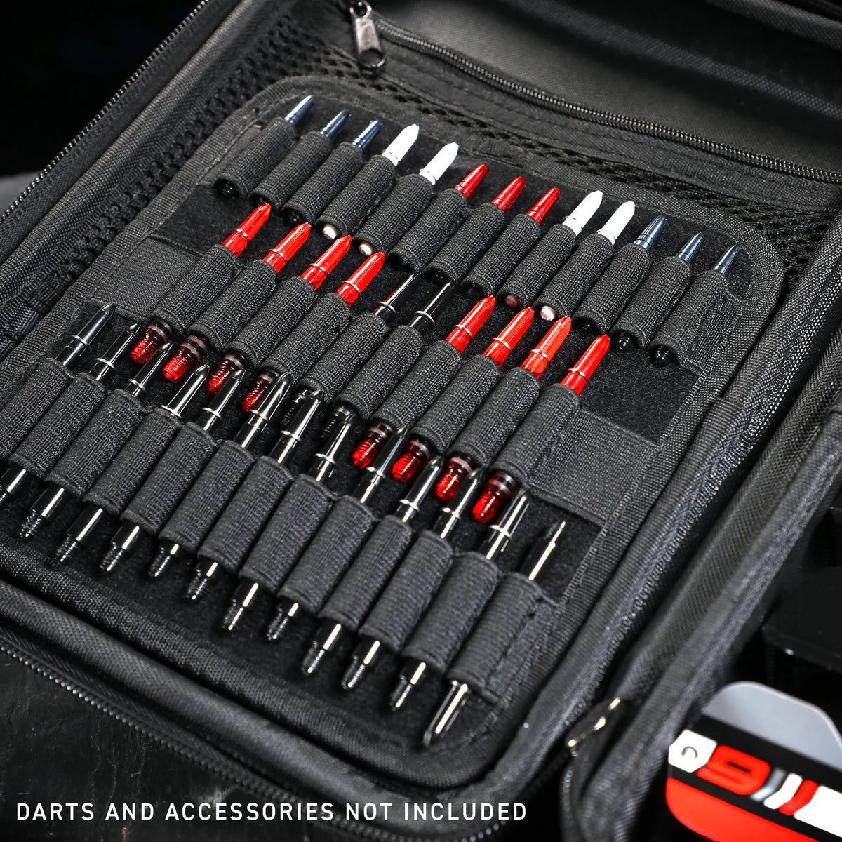 Angled close-up of open red darts case with elastic holders for dart barrels, shafts, and accessories, showing spacious organized storage