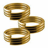 Close-up of three gold dart shaft spring O-rings isolated on white background, showing coiled design for secure nylon dart shafts