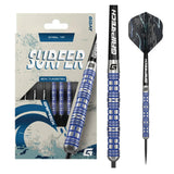 Full view of Surfer 80% tungsten darts in retail packaging, showing blue grip rings, detailed steel tip barrels, and striking dart flights