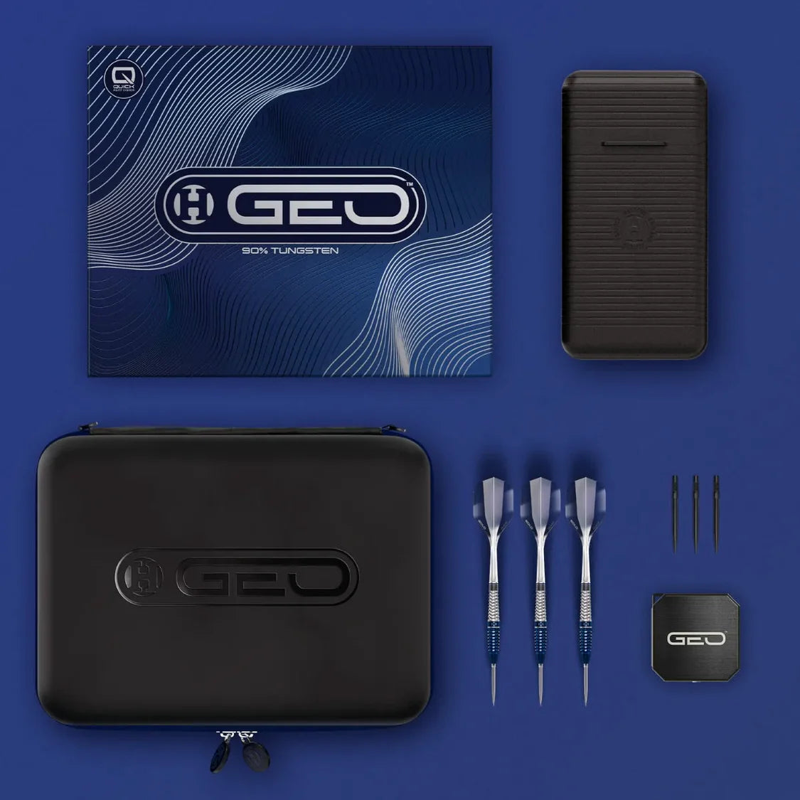 Top-down view of 90% tungsten darts set with three assembled darts, case, packaging, spare tips, and spare flights arranged neatly.