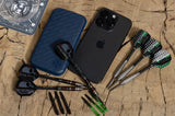 Top-down view of slim darts case next to darts, dart shafts, a smartphone, and accessories on a wood surface for scale