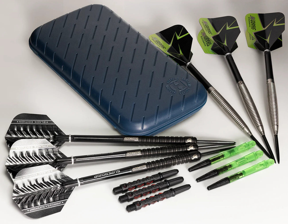 Top-down view of slim darts case with six assembled steel tip darts, extra shafts, and flights displayed for dart storage and accessories.
