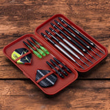 Top-down view of open slim darts case displaying six darts, flights, and shafts organized in molded compartments.