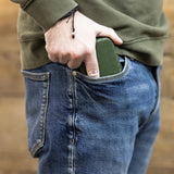 Slimcase darts case in hand fitting easily into jeans pocket, showcasing compact portable dart storage with textured grip