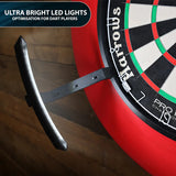 Angled view of dartboard light attachment illuminating mounted dartboard with bright LED strip for optimal dart visibility