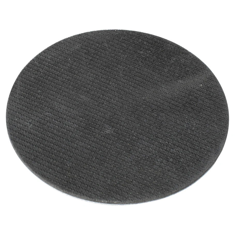 close-up angled view of single round dartboard coaster with textured black surface for darts accessories