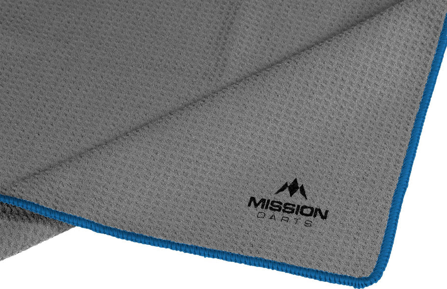 Close-up angled view of grey waffle hand towel with blue edging, highlighting textured grip ideal for dart players