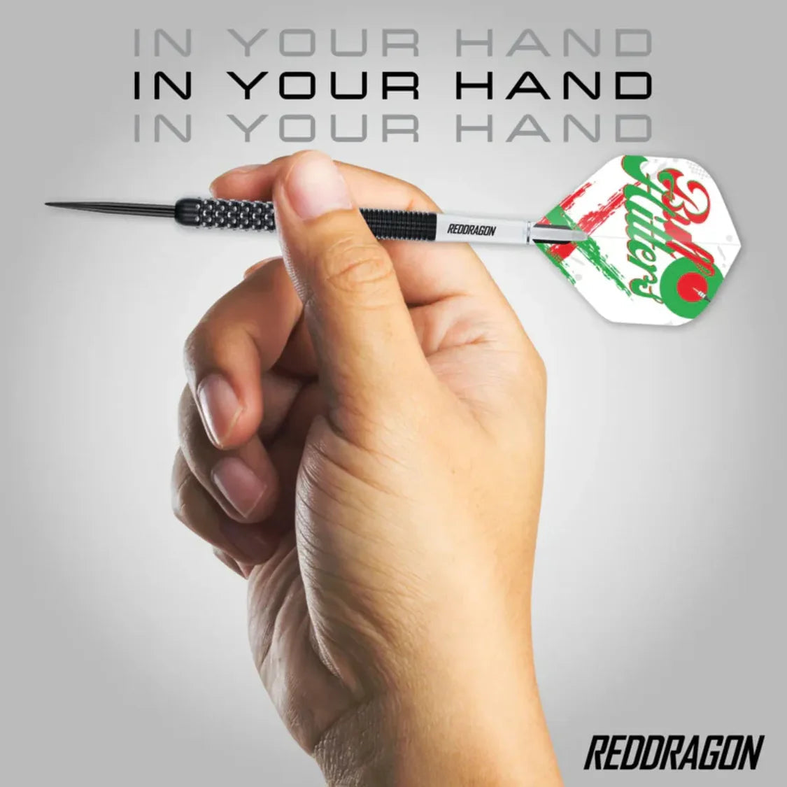 Hand holding Bull Hitters V1 tungsten dart showing textured grip, detailed flight design, and angled in-use demonstration