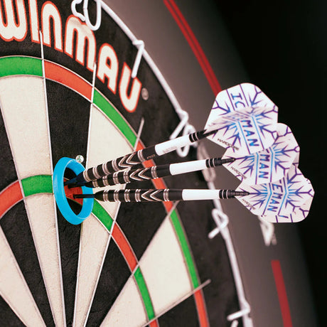 Angled close-up of darts grouped in a blue practice ring on dartboard, highlighting Iceman flights and grooved barrel grips