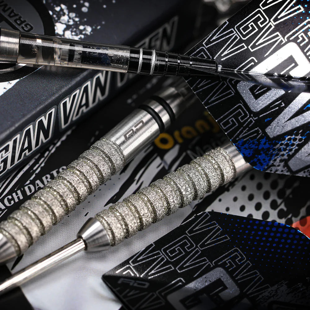 Macro close-up of 90% tungsten darts showing textured grip barrels, black and blue flights, arranged near Gian Van Veen packaging