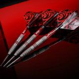 angled close-up of three 90% tungsten darts with patterned flights, detailed barrel grip, red accents on black reflective surface