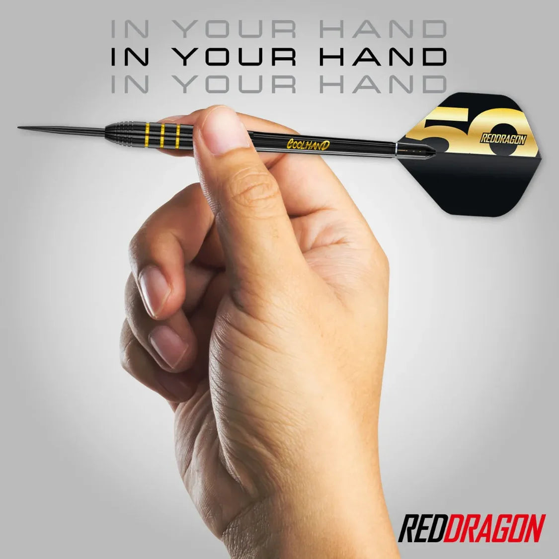 Limited edition tungsten dart held in hand, grip texture and gold 50th anniversary flight detail clearly visible