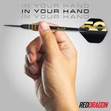 Limited edition tungsten dart held in hand, grip texture and gold 50th anniversary flight detail clearly visible