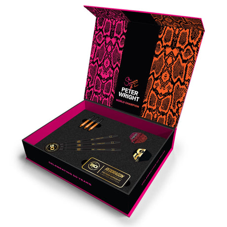 Limited edition 90% tungsten darts set in open display box, showing three darts, flights, shafts, and anniversary accessories on foam insert