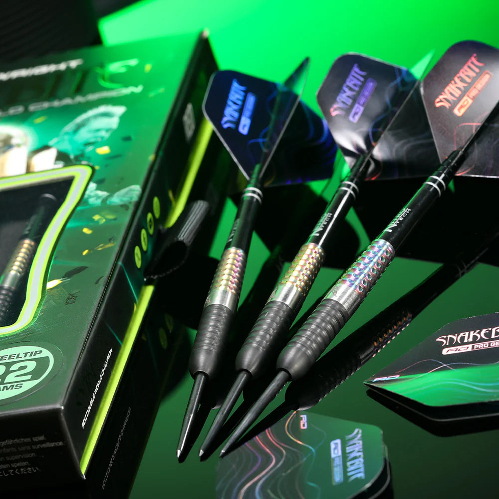 Angled display of three 90% tungsten darts with textured barrels and Snakebite flights beside retail packaging on reflective surface