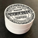 Angled close-up of Snakebite Peter Wright precision grip wax tub in packaging, lid design visible for dart grip enhancement