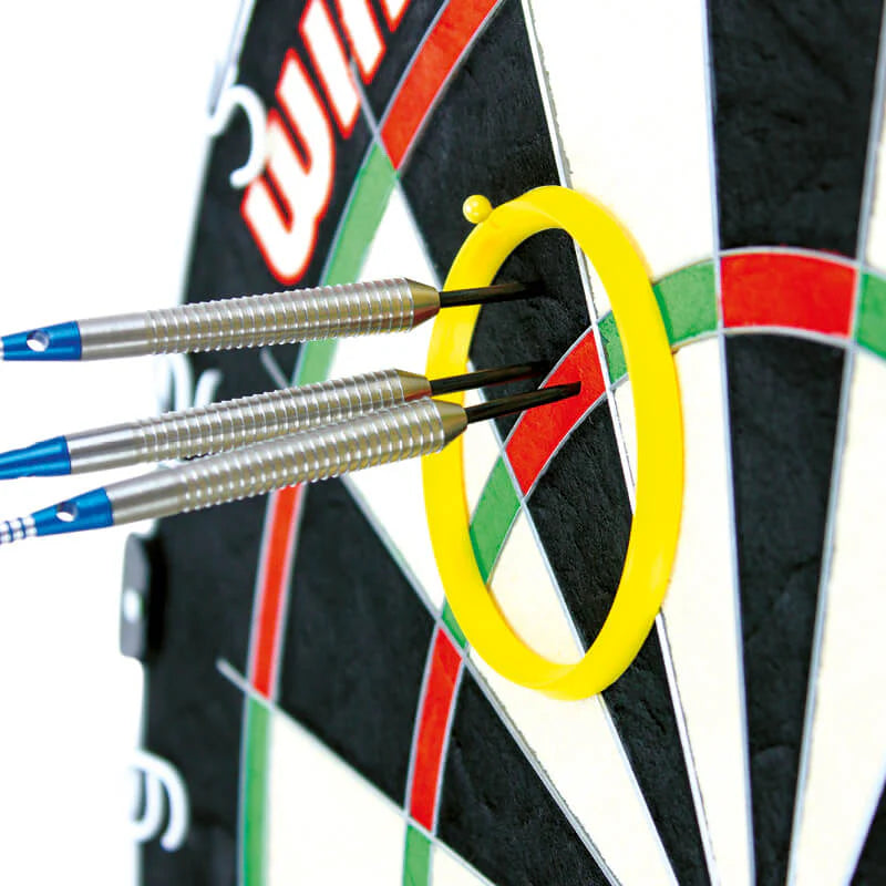 Close-up angled view of three steel tip darts grouped inside a yellow practice ring on a dartboard for precision aiming practice