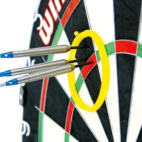 Close-up angled view of three steel tip darts grouped inside a yellow practice ring on a dartboard for precision aiming practice