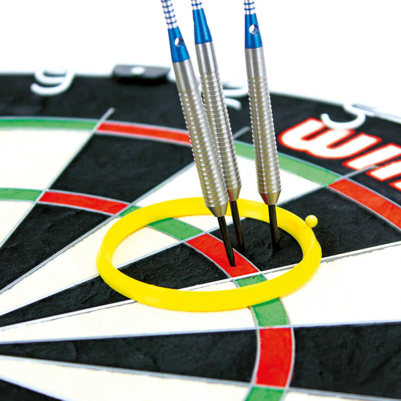 Close-up of yellow darts practice ring on dartboard with three grouped steel tip darts for precision training