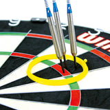 Close-up of yellow darts practice ring on dartboard with three grouped steel tip darts for precision training