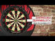 Tournament-size dartboard mounted on brick wall, full front view, highlighting thin wiring and enhanced durability for home or pro darts setup