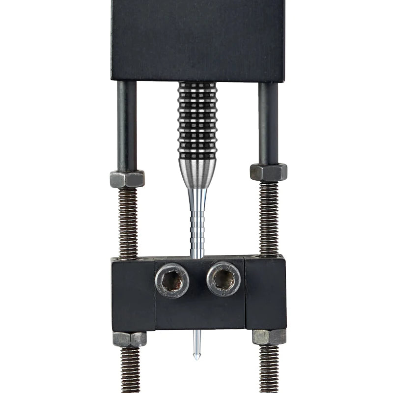 Close-up dart point in clamp with precision grip texture, machined spearhead tip, steel dart accessory for board retention