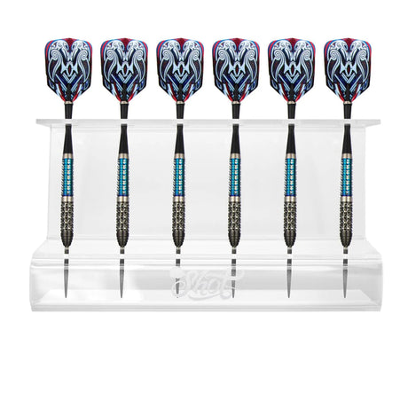 Six steel tip darts with blue grips and patterned flights displayed upright in a transparent dart stand on white background