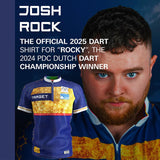 Full view of Josh Rock darts shirt on display, navy blue and yellow design, lifestyle background features darts player in matching shirt.