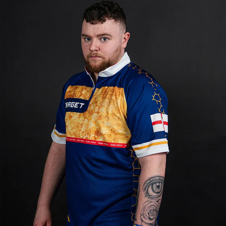 Model wearing Josh Rock darts shirt angled view, showing blue and gold pattern, sleeve details, and comfortable darts apparel fit