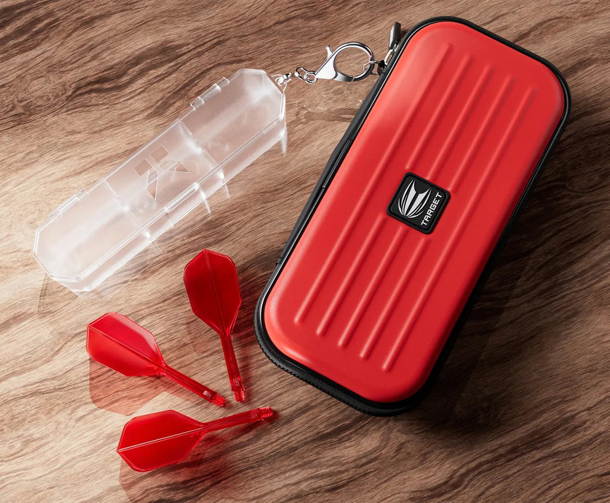 Top-down view of red dart case with zip closure, clear tube with keychain clip, and three red dart flights for K Flex system on wood background