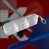 Transparent dart flight and shaft case with keychain clasp, angled view on blurred dartboard background