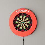 Target Notched Surround in red mounted on a wall with a dartboard